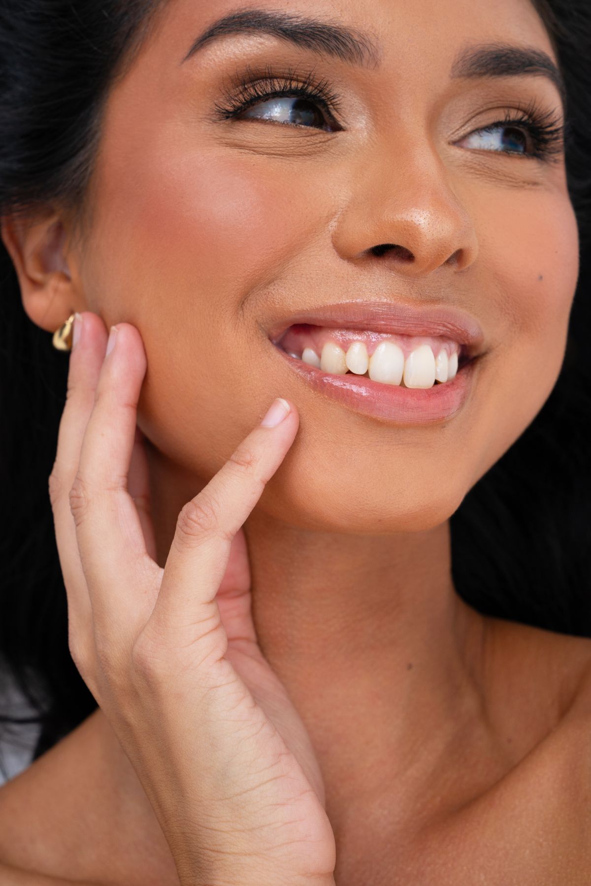 Client in a white robe after a facial